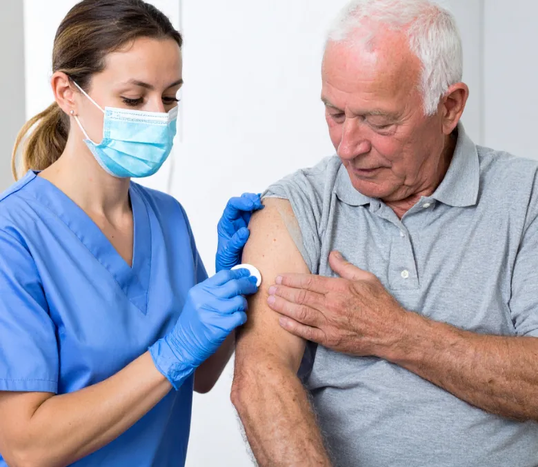 A provider applying a dressing to a resident's arm