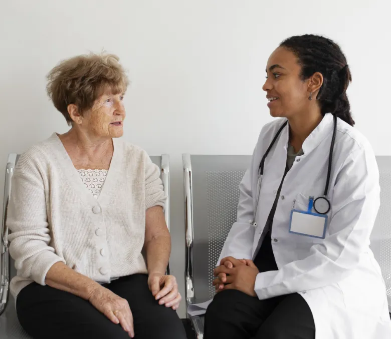 A clinician sitting and talking with a resident