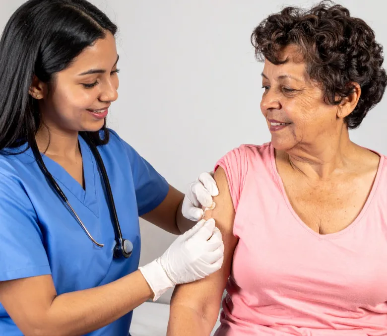 A clinician examining a resident’s arm during a visit